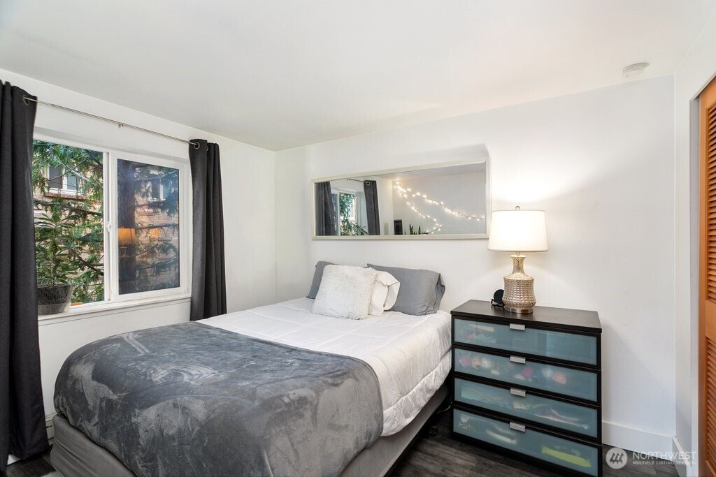 4831 Fauntleroy Way Southwest, Unit 206 Seattle, WA 98116 - Photo 9 of 21 a bedroom with a bed and a night stand