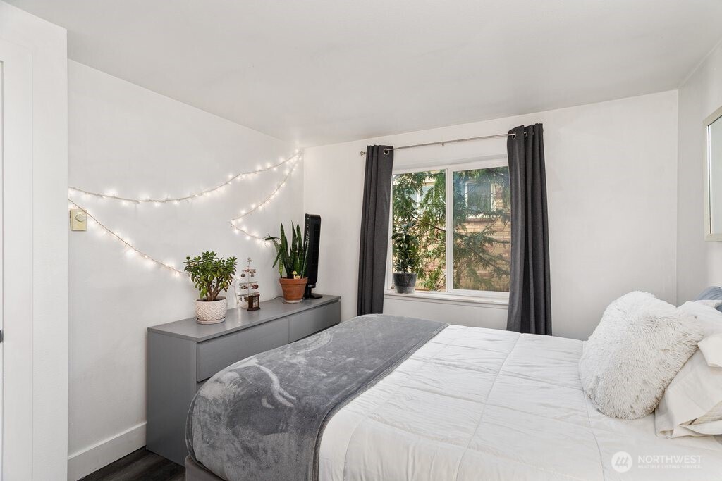 4831 Fauntleroy Way Southwest, Unit 206 Seattle, WA 98116 - Photo 10 of 21 a bedroom with a large bed and large windows