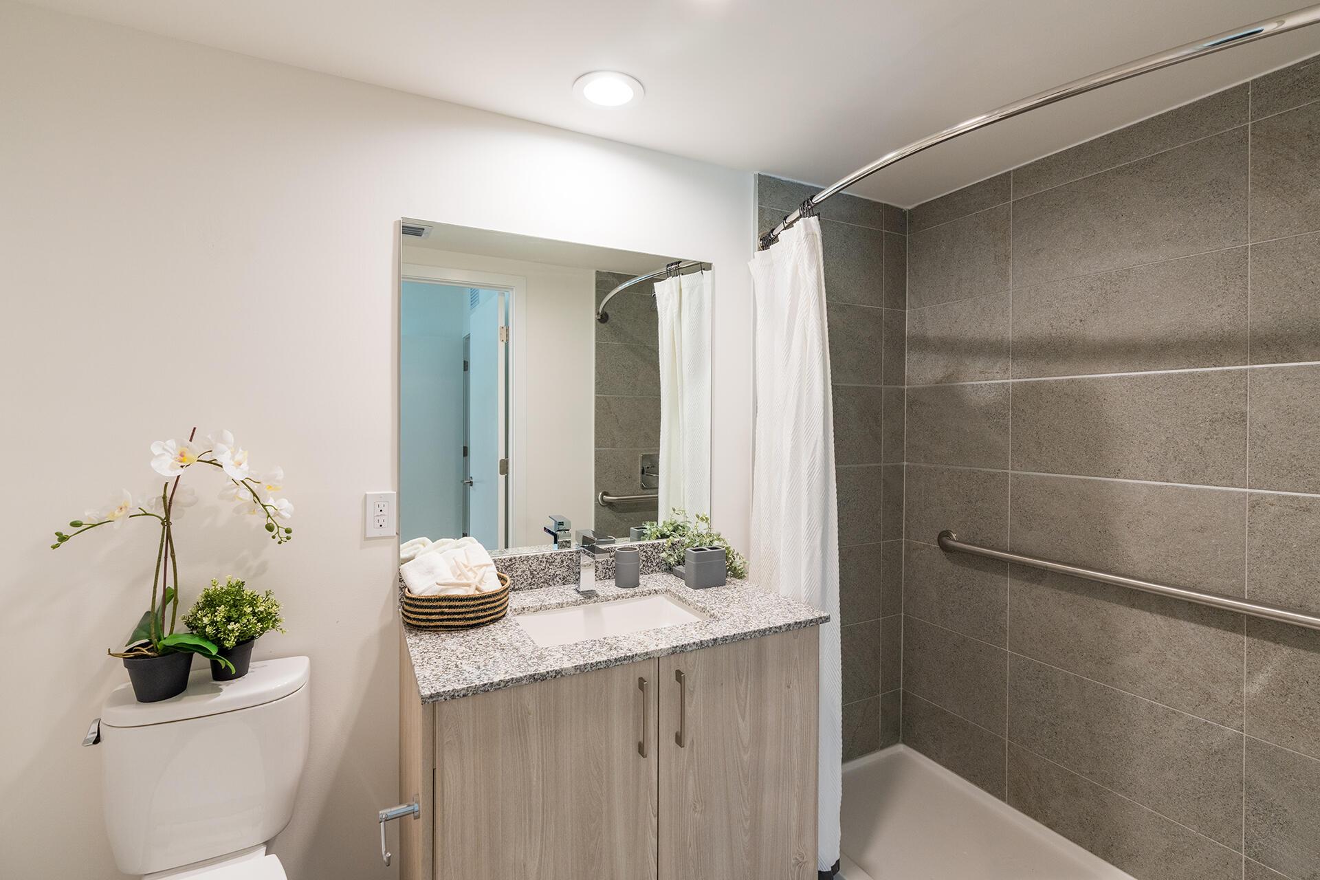 5961 Southwest 68th Street, Unit B302 South Miami, FL 33143 - Photo 10 of 20 a bathroom with a granite countertop sink a toilet a mirror and shower