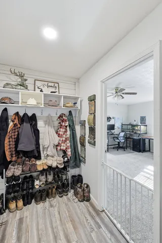 a view of walk in closet with clothes and shoes
