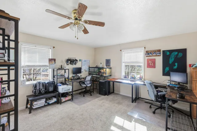 a view of a workspace with furniture and a window