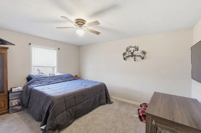 a bedroom with a bed and a chandelier