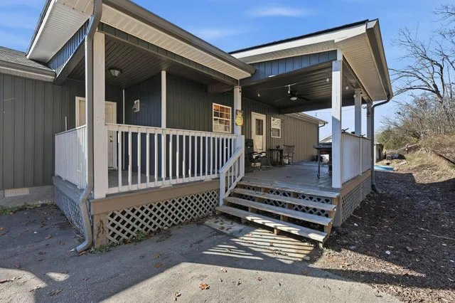 a view of a brick house with wooden floor and a fence