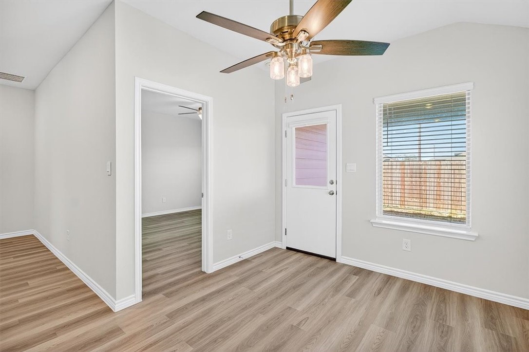 1626 Comfy Way Corpus Christi, TX 78418 - Photo 14 of 40 a view of a livingroom with wooden floor and a ceiling fan