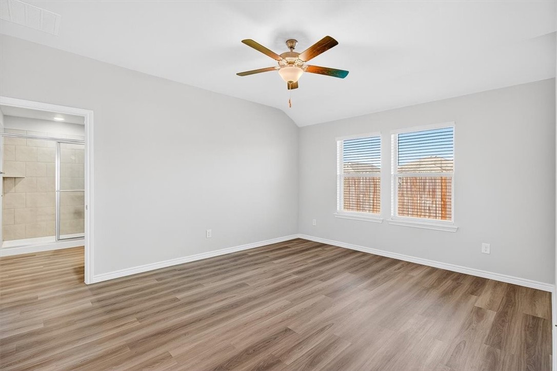 1626 Comfy Way Corpus Christi, TX 78418 - Photo 16 of 40 a view of an empty room with wooden floor and a window