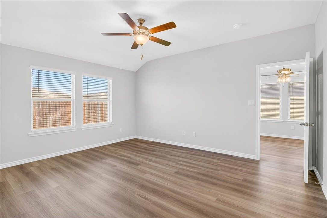 1626 Comfy Way Corpus Christi, TX 78418 - Photo 17 of 40 an empty room with wooden floor and windows