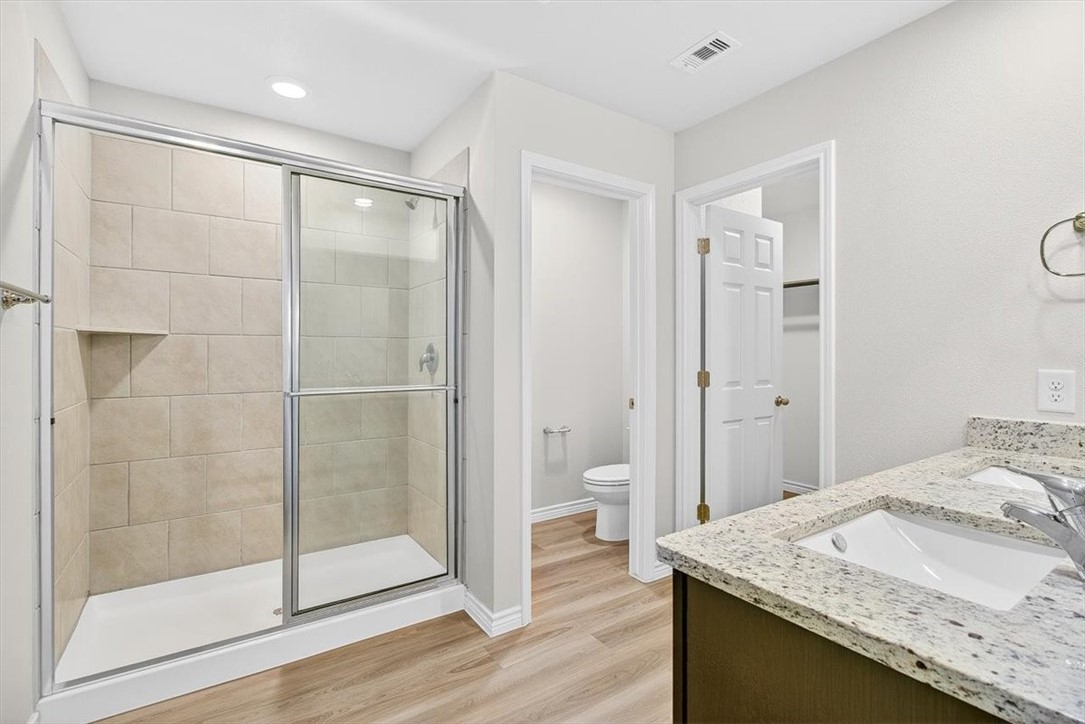 1626 Comfy Way Corpus Christi, TX 78418 - Photo 19 of 40 a bathroom with a granite countertop sink a mirror and shower