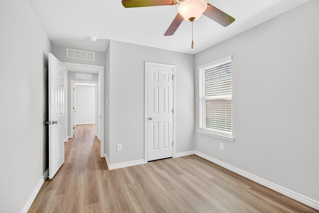 1626 Comfy Way Corpus Christi, TX 78418 - Photo 30 of 40 a view of an empty room with wooden floor and a window