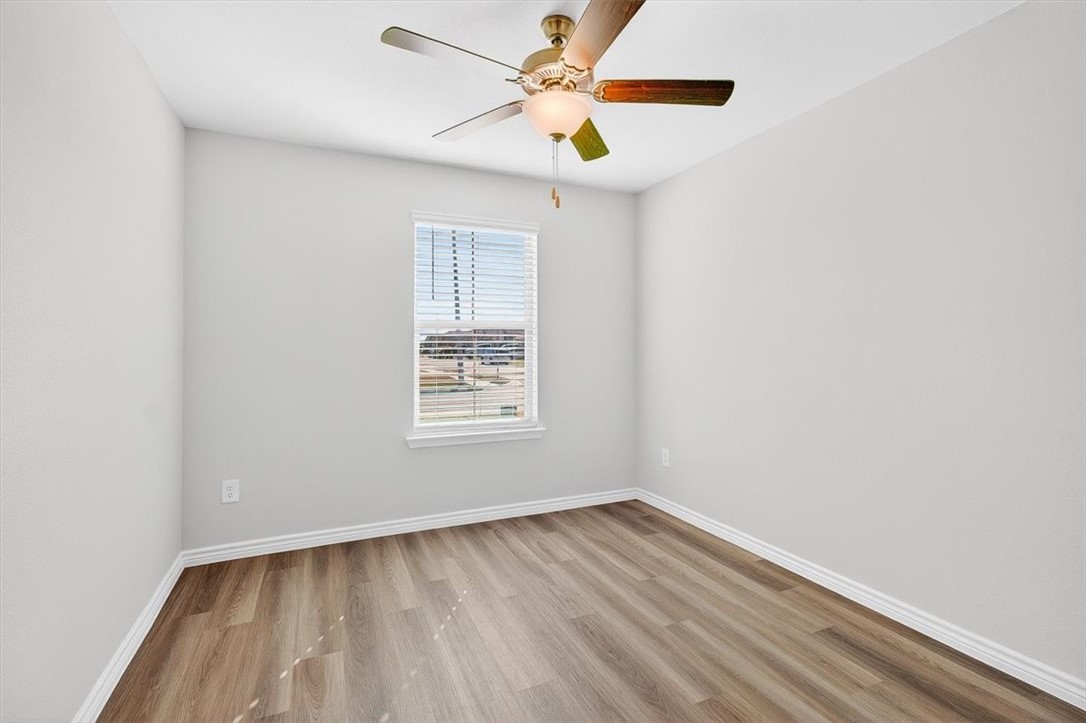 1626 Comfy Way Corpus Christi, TX 78418 - Photo 31 of 40 an empty room with a window and a ceiling fan