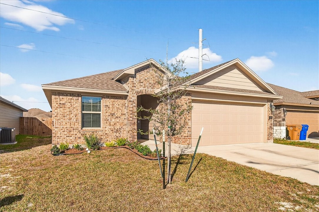 1626 Comfy Way Corpus Christi, TX 78418 - Photo 32 of 40 a front view of a house with a yard