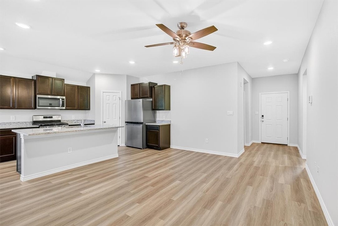 1626 Comfy Way Corpus Christi, TX 78418 - Photo 4 of 40 a view of kitchen with cabinets stainless steel appliances and wooden floor
