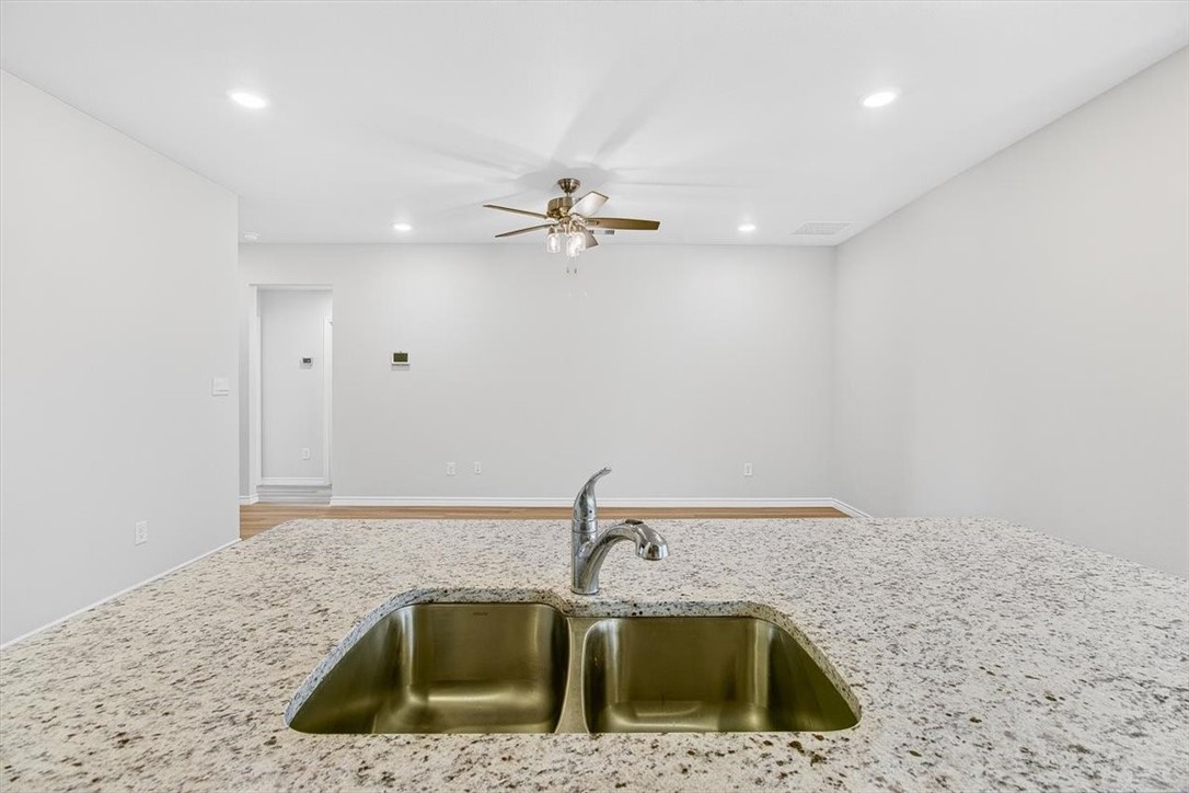 1626 Comfy Way Corpus Christi, TX 78418 - Photo 6 of 40 a kitchen with a sink a refrigerator and chandelier