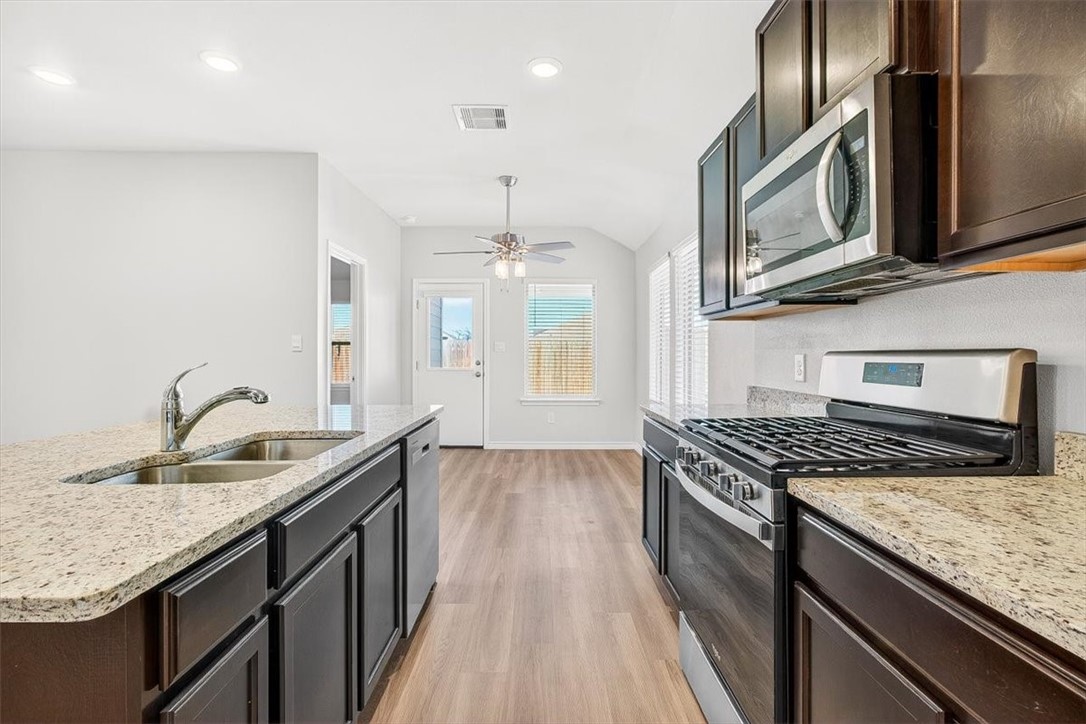 1626 Comfy Way Corpus Christi, TX 78418 - Photo 8 of 40 a kitchen with granite countertop stainless steel appliances window a sink and a counter space