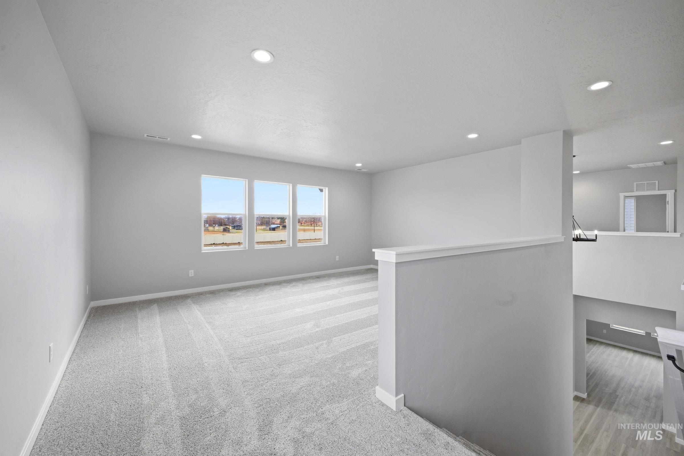 13672 Redway Court Caldwell, ID 83607 - Photo 18 of 34 Empty room with light carpet and recessed lighting