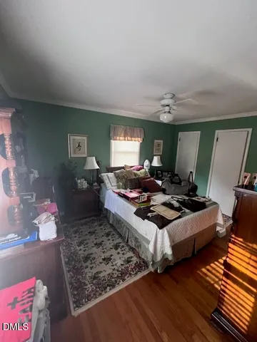 a living room with furniture hard wood floor and a lamp