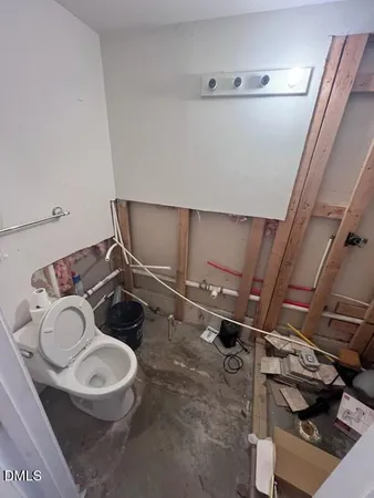a bathroom with a sink mirror vanity and toilet