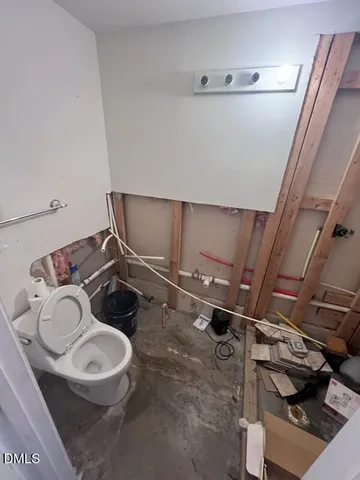 a bathroom with a sink mirror vanity and toilet