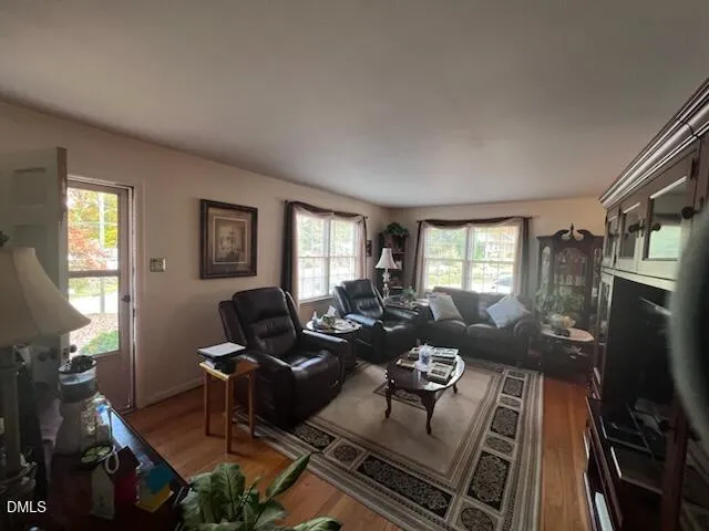 a living room with furniture fireplace and a window