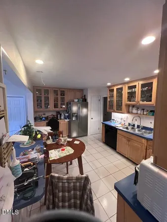 a kitchen with stainless steel appliances kitchen island granite countertop a stove refrigerator and cabinets