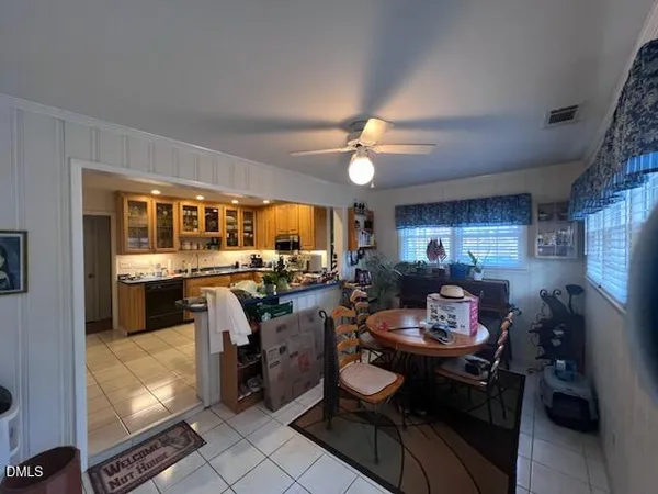 a view of a dining room with furniture and a kitchen