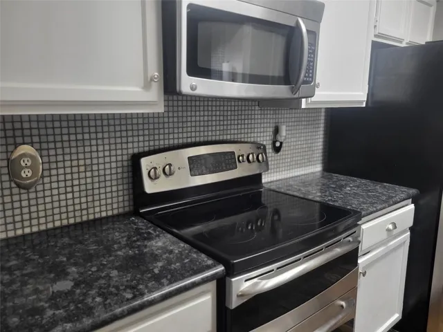 a stove top oven sitting inside of a kitchen