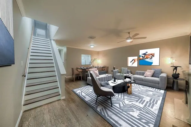 a living room with furniture and wooden floor