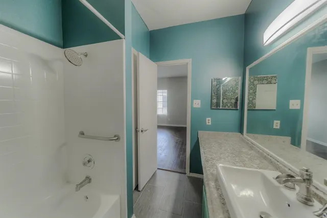 a bathroom with a bathtub and a shower