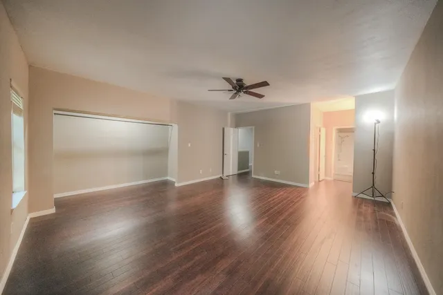 a view of a room with wooden floor and white walls