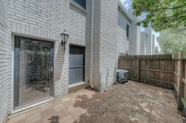 a view of a backyard with a small cabin and wooden fence