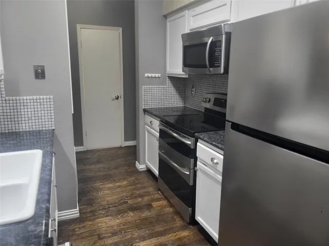 a kitchen with a sink and a stove top oven