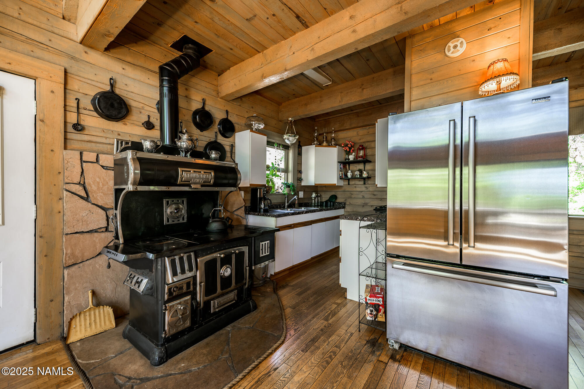4680 Mormon Lake Road Mormon Lake, AZ 86038 - Photo 12 of 34 a kitchen with stainless steel appliances granite countertop a refrigerator a stove and a sink with wooden floor