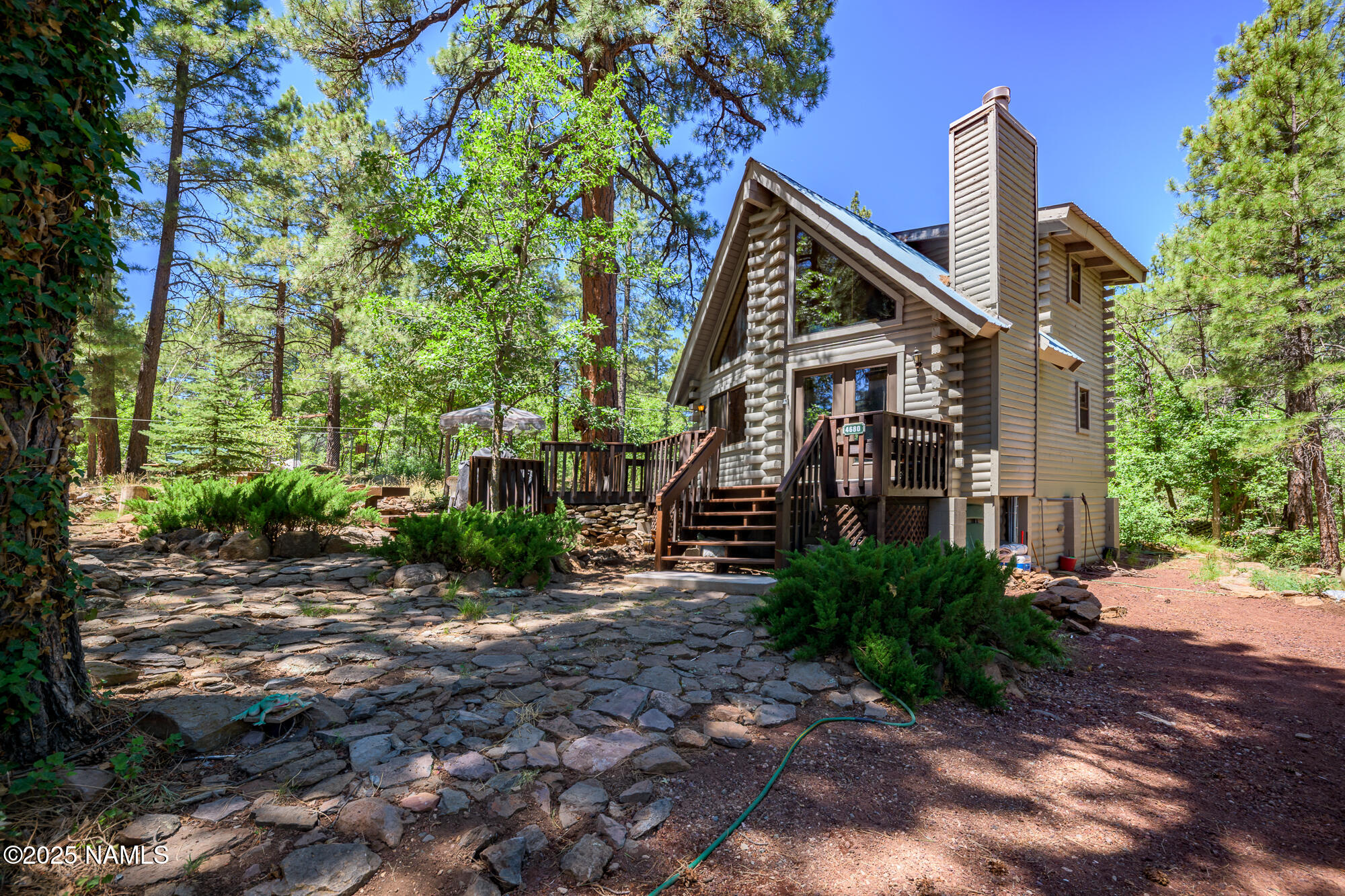 4680 Mormon Lake Road Mormon Lake, AZ 86038 - Photo 4 of 34 a view of a house with a small yard and large trees