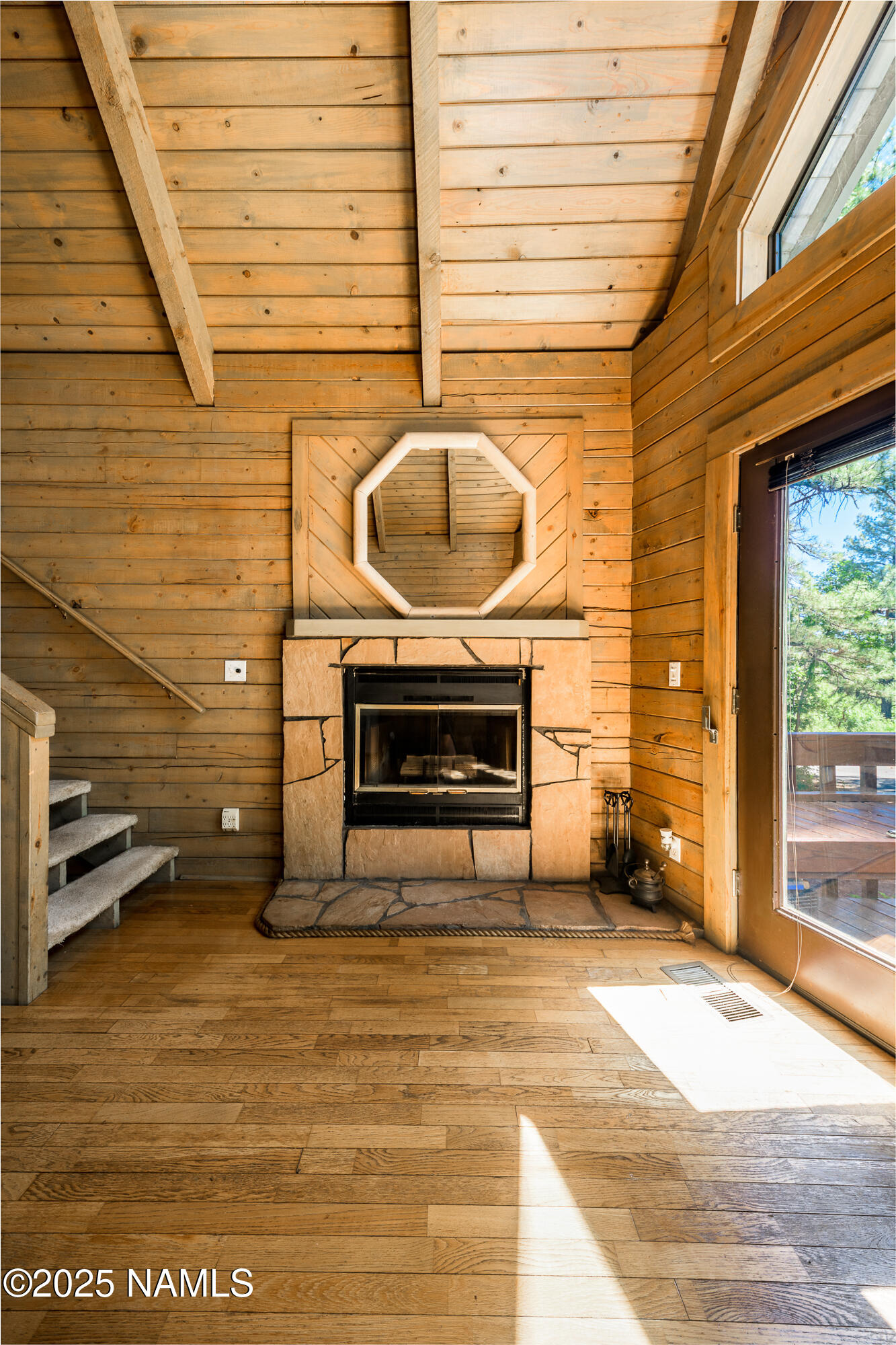 4680 Mormon Lake Road Mormon Lake, AZ 86038 - Photo 9 of 34 a living room with a fireplace and a table