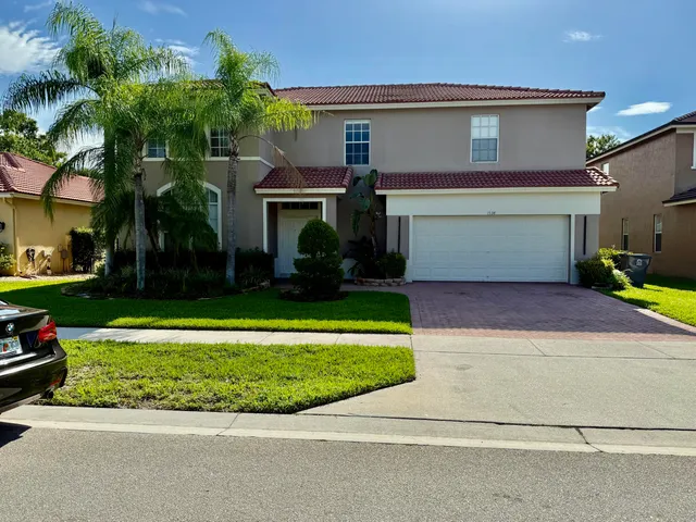 a front view of a house with a yard and garage