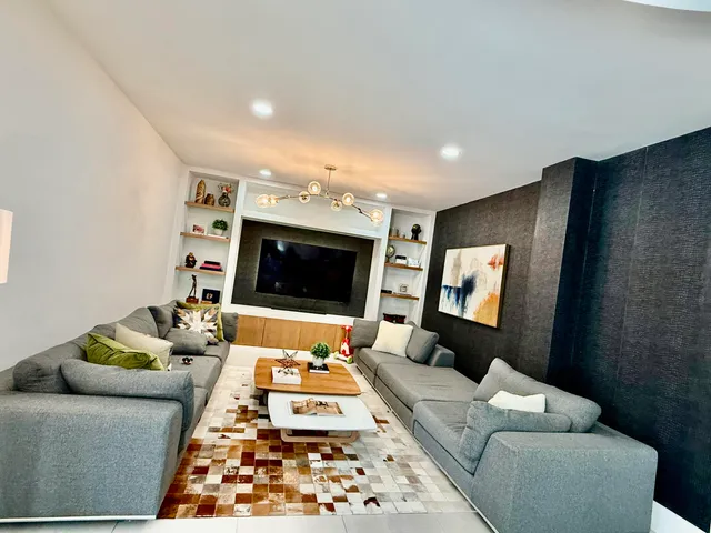 a living room with furniture and a flat screen tv