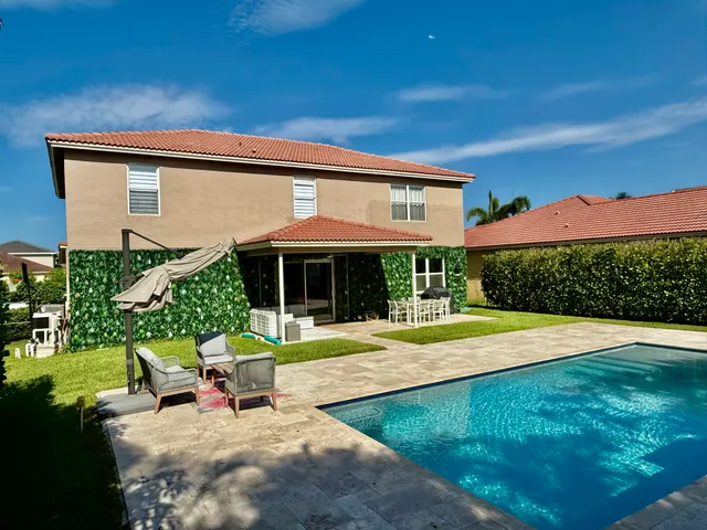 a view of a house with a yard porch and sitting area