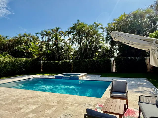a view of a backyard with sitting area