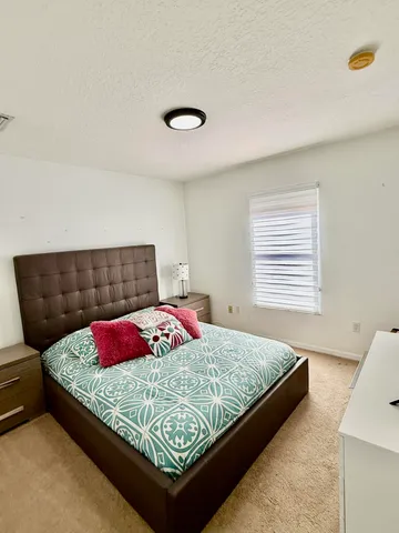 a bedroom with a bed and window