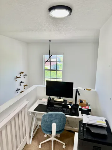 a view of a workspace with furniture