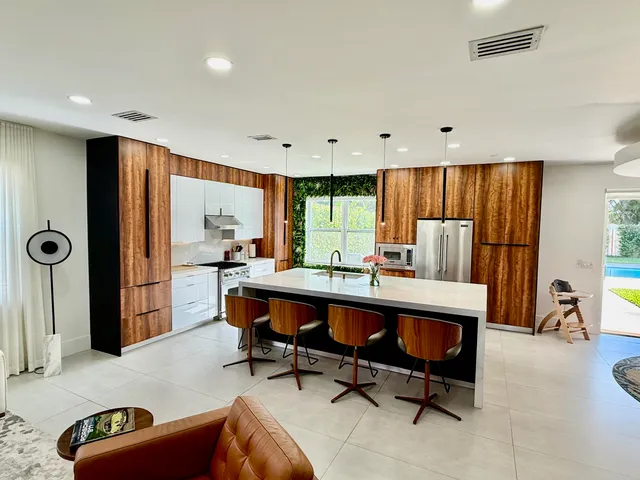 a living room with furniture a rug and a large window