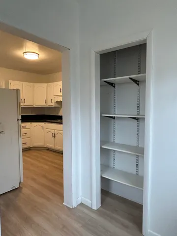 a view of a kitchen with a sink and a refrigerator