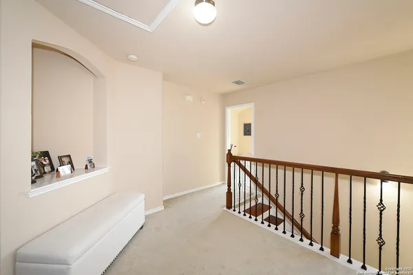 a hallway with white cabinets