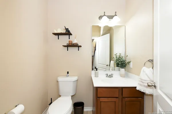 a bathroom with a sink and mirror with toilet