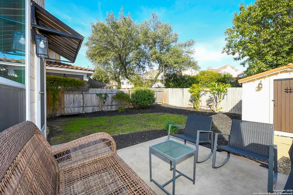 a view of backyard with outdoor seating and green space