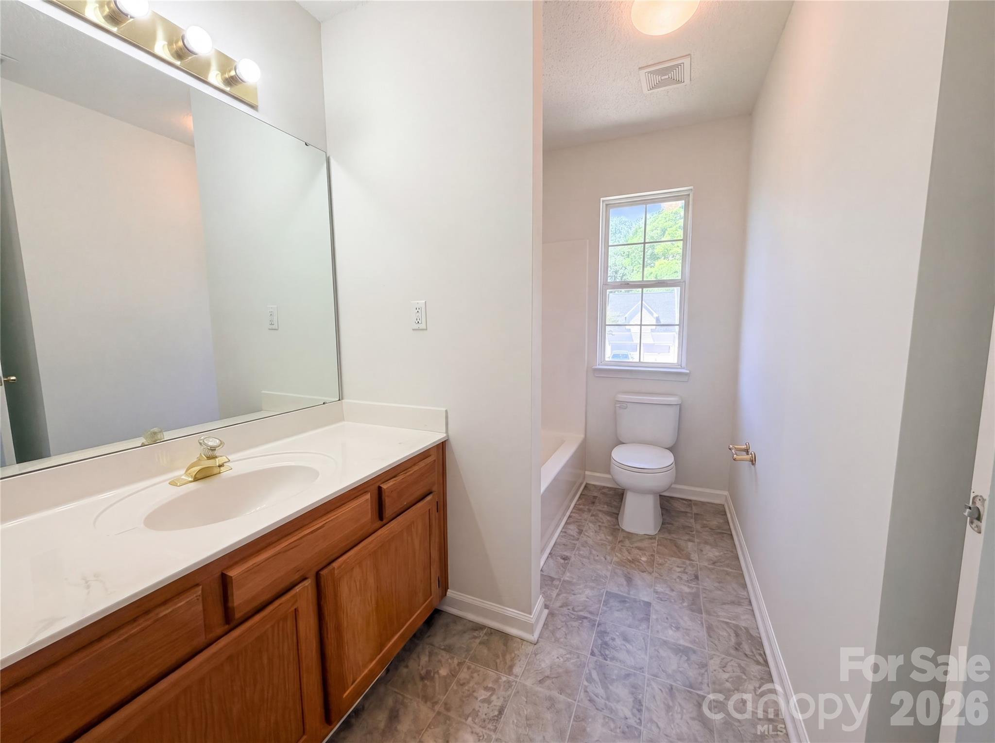 7423 Henderson Park Road Huntersville, NC 28078 - Photo 15 of 16 a bathroom with a sink a toilet and a window