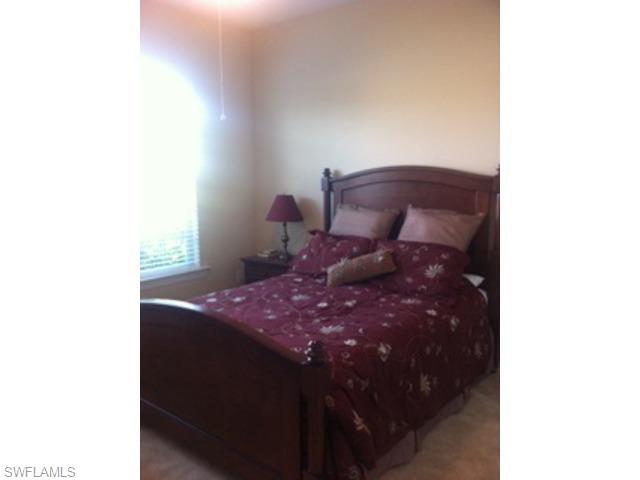 8248 Quaker Place Naples, FL 34104 - Photo 7 of 14 a bath room with a bed