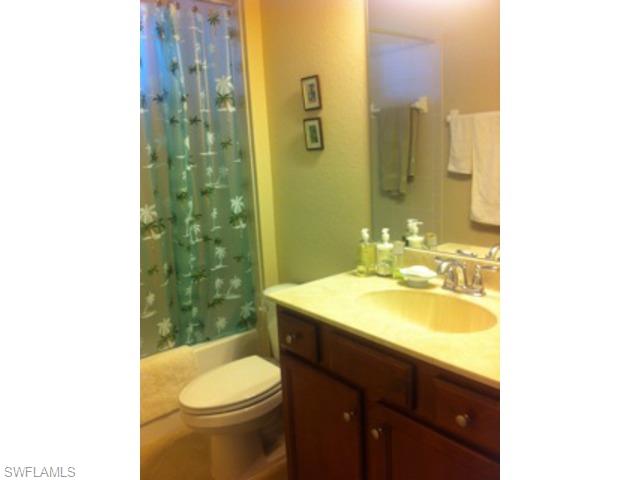 8248 Quaker Place Naples, FL 34104 - Photo 8 of 14 a bathroom with a sink toilet and shower