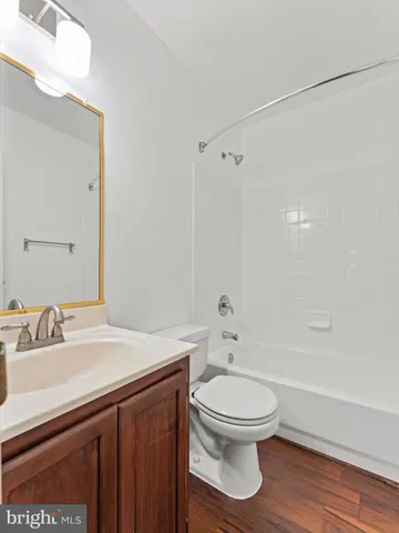 a bathroom with a sink toilet a mirror and shower