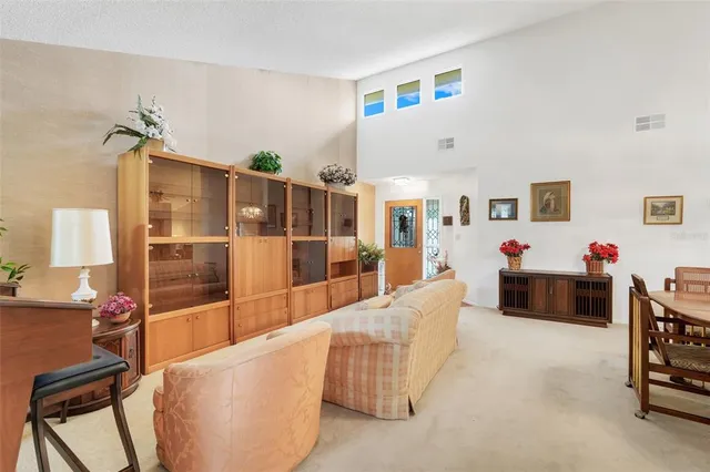 a living room with furniture a flat screen tv and a table