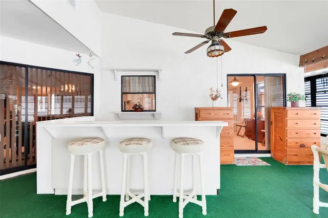 a view of a kitchen with furniture and a ceiling fan